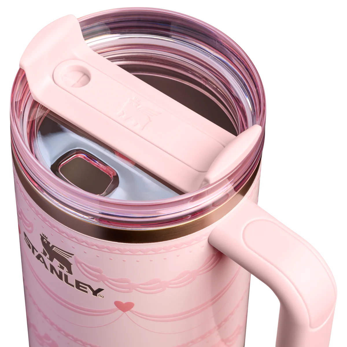 Close-up of Stanley Quencher H2.0 FlowState lid with rotating cover and straw opening, showcasing leak-resistant design on pink insulated tumbler.