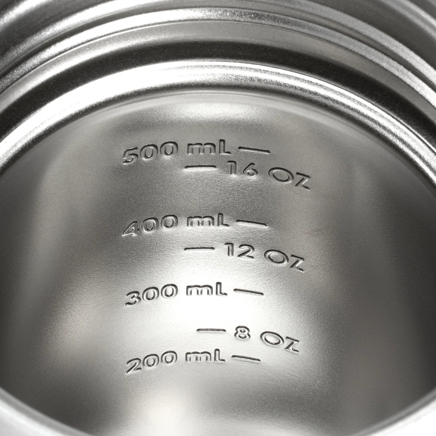 Close-up of the stamped measurement markings inside the Stanley Activate Shaker Bottle, displaying ounces and milliliters.
