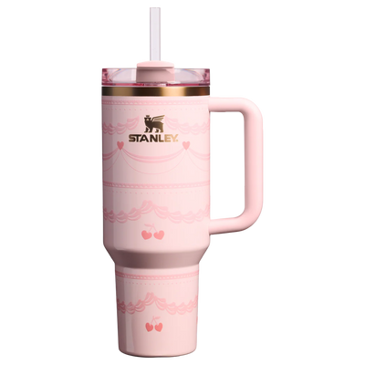 Stanley Quencher H2.0 FlowState 40oz tumbler in Pink Velvet Cake design with handle and straw lid, featuring soft pink finish with heart and cherry detailing.